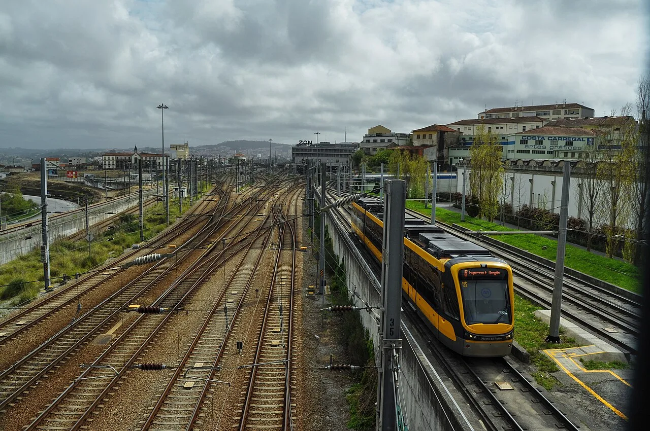 Metro train beside the railway tracks at Campanhã