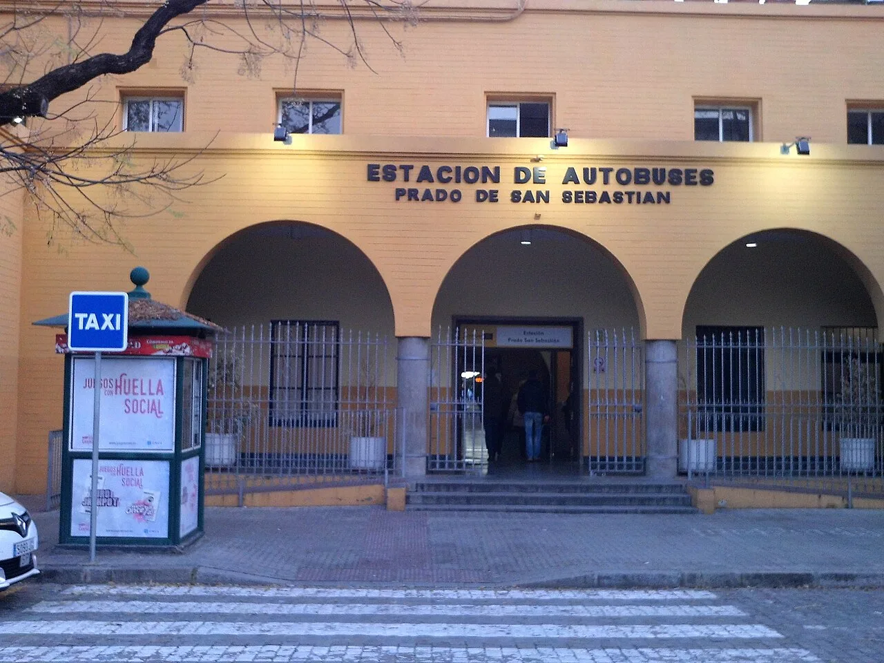 Yellow facade and signed entrance of Prado de San Sebastián coach terminal