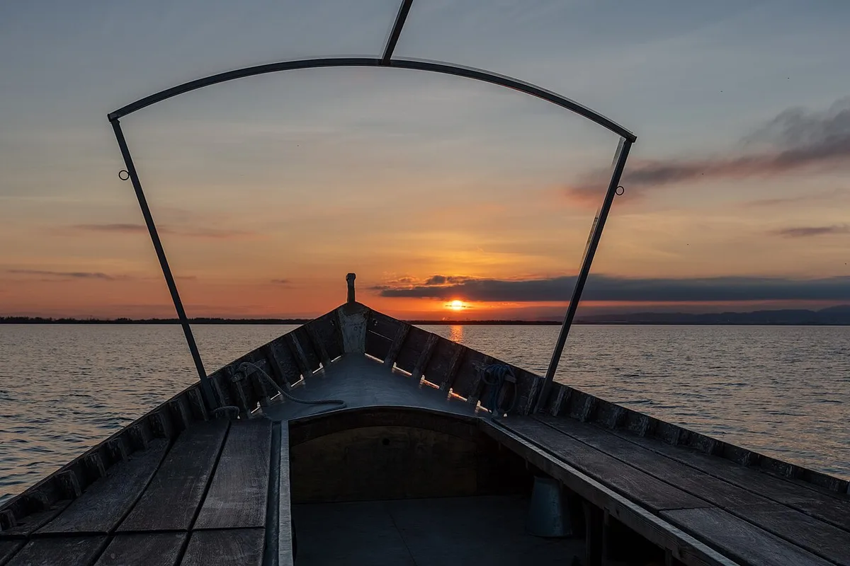 Traditional boat on Albufera lagoon at sunset